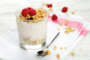 Muesli with yogurt and raspberries in a glass 
