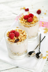 Muesli with yogurt and raspberries in a glass 