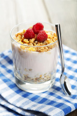 Muesli with yogurt and raspberries in a glass 