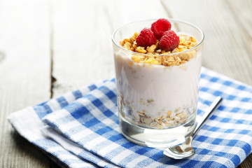 Muesli with yogurt and raspberries in a glass 