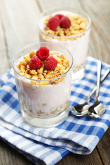 Muesli with yogurt and raspberries in a glass 