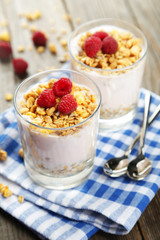 Muesli with yogurt and raspberries in a glass 