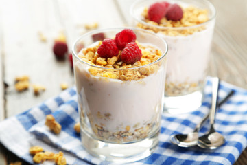 Muesli with yogurt and raspberries in a glass 