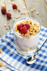 Muesli with yogurt and raspberries in a glass 