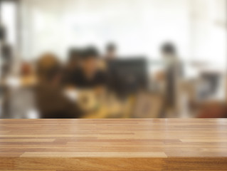 Empty wooden table and blurred business people background