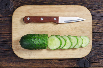 Sliced green cucumber and knife