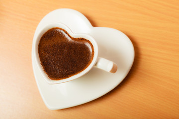 Coffee in heart shaped cup mug. Caffeine energy.