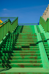 Green concrete stairs stairway with railing.