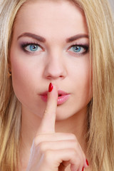 Naklejka premium Woman asking for silence finger on lips hush hand gesture.