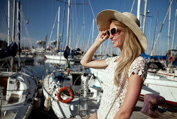 Fototapeta na wymiar Attractive blonde woman in harbor.
