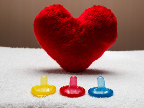 Colorful condoms and red heart