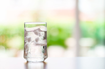 glass of Cool fresh drink with ice cube on the  table