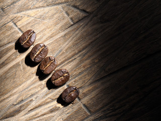 Coffee crop beans on wood texture background