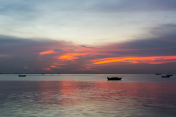 silhouette of Small fishing boats on the sea during sunset
