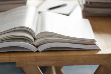 opened book pile put on table