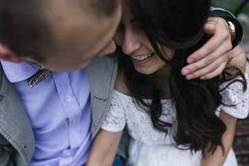 Young European couple cuddling on a park bench