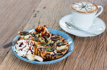 toast topped with sliced bananas and chocolate.