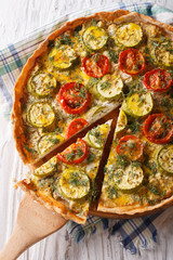 quiche with tomatoes and zucchini closeup. vertical top view
