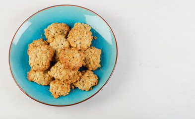 Freshly baked oatmeal cookies in  blue plate.