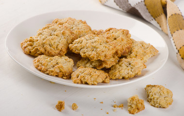 Freshly baked oatmeal cookies on a white plate.