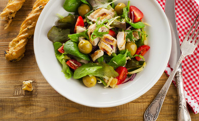 Chicken healthy salad on a rustic wooden table