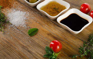 Dressing ingredients on  rustic wooden background.