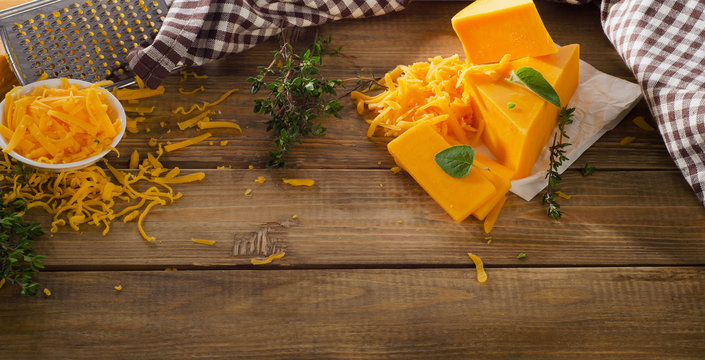 Cheddar Cheese on a rustic wooden background.