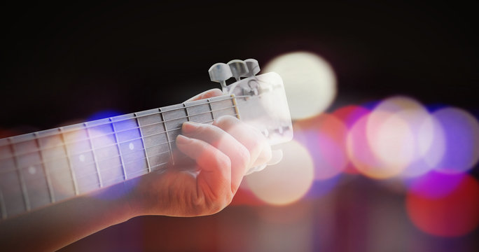 Man playing acoustic guitar with outdoor background