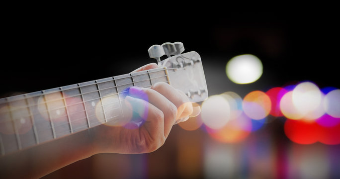 Man playing acoustic guitar with outdoor background