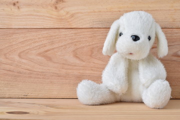 Plush dog toy with wooden background
