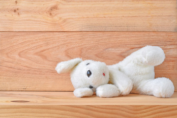 Plush dog toy with wooden background