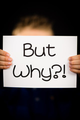 Boy holding But why sign