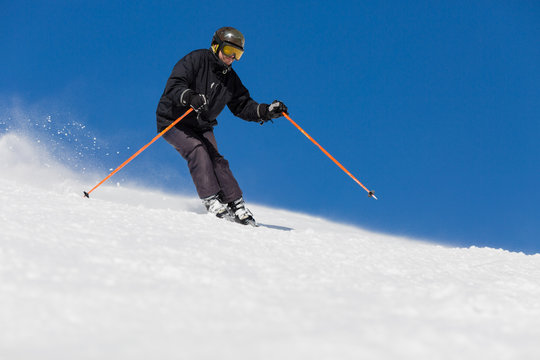Male skier skiing at ski resort