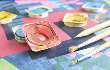 Messy used water color paint box and paintbrush