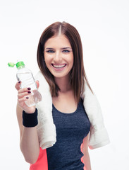 Smiling fitness woman holding bottle of water