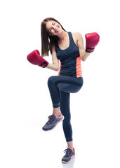 Sporty woman celebrating her victory in boxing gloves