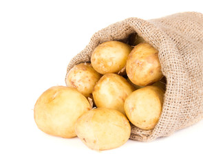 Raw potatoes in burlap bag isolated on white - 83897928
