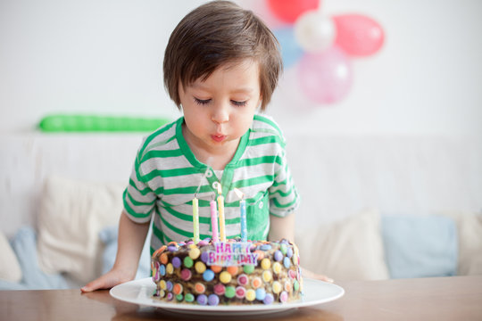 Beautiful adorable four year old boy in green shirt, celebrating