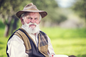 Senior farmer with organic cheese outside in nature