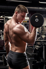 Fototapeta na wymiar Man during his workout in gym