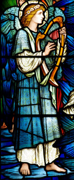 An angel making music with a harp (stained glass)
