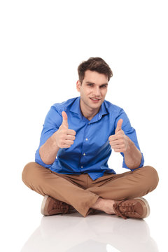  man showing the thumbs up gesture with both hands