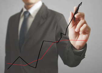Businessman drawing graphics