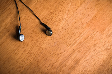 earphones on wood board