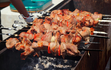 Shish kebabs pork on the grill in the cooking process.