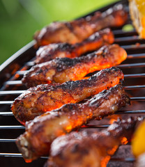 Delicious chicken legs on garden grill