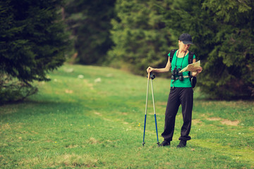 Hiker looking on map in forest