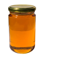 Glass jar of honey on white