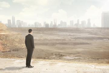 Asian business man looking at the destroyed city