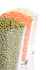 full glasses with mung, lentil and chick-pea isolated on white